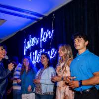 Philly passes the mic to grads on stage for a toast